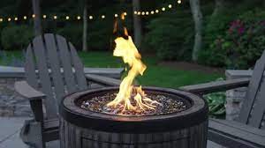 Gas Fire Pit Is Lit On An Outdoor Patio