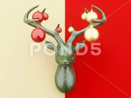 A Green Deer Head On The Wall With