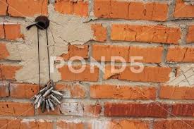 Rope On A Nail Against A Brick Wall