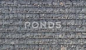 Gabion A Stone Wall With A Metal Grid
