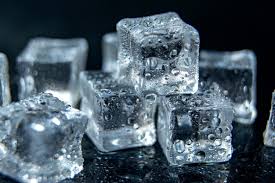 Ice Cubes On Black Isolated Glass