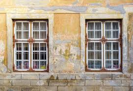 Old Windows In Stucco Facade