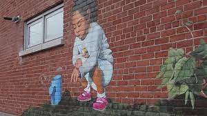 Brick Wall Graffiti Of Child And Plant