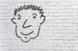 Head Graffiti On A White Brick Wall