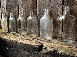 Old Glass Bottles On Wooden Beam