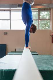 male gymnast doing handstand on balance