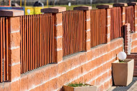 Wooden Fence On Brick Wall Stock Photo