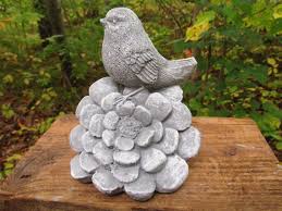 Cement Bird Resting On Flower Blossom