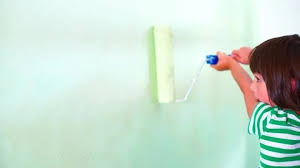 Child Paints The Wall With A Roller