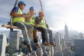 three construction workers sitting on