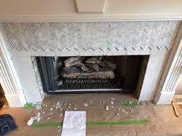 Herringbone Marble Tile To A Fireplace