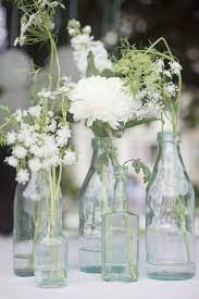 Glass Bottles And Simple White Flowers