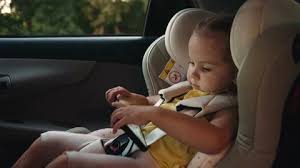 The Child Sits In A Child Car Seat