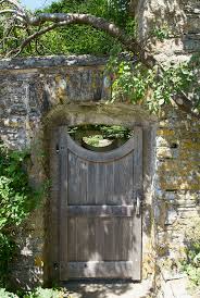 Old Garden Gate In Stone Wall Stock