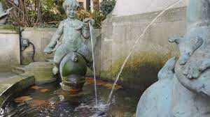 Old Fountain Statue Of A Baby On A