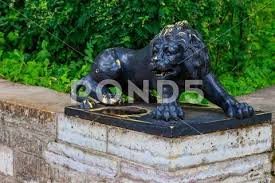 Black Statue Of The Lion On Large Stone
