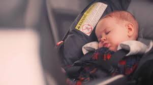 A Baby Sleeping In Her Car Seat Stock