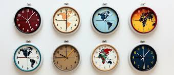 Four Timezone Wall Clocks Showing