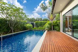 Swimming Pool And Decking In Garden Of