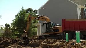 Backhoe Digging Out Basement Stock