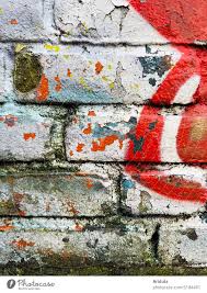 Graffiti In Layers On Brick Wall In