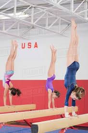 gymnasts doing handstands on balance