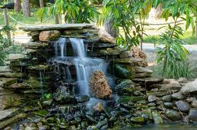 Artificial Waterfall In A Pond In The Park