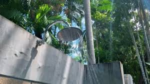 An Outdoor Shower In A Tropical Garden