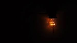 In The Dark A Dim Light Bulb Lights Up