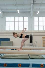 little gymnast practicing routine on