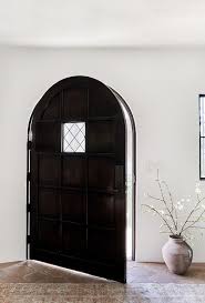 Arched Dark Wood Paneled Front Door