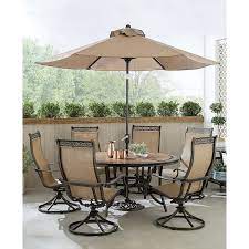 Hanover Monaco 7 Piece Outdoor Dining Set With 6 Sling Swivel Rockers 60 In Tile Top Table And 9 Ft Umbrella