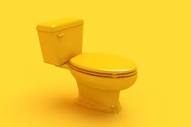 Premium Photo Yellow Ceramic Toilet