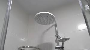 Water Flows From Shower Head And Faucet