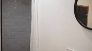 Grey Shower Unit In Hotel Bathroom