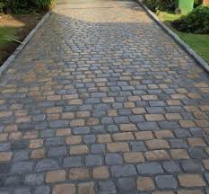 Teak And Black Cobbles For Landscaping