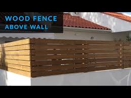 Install A Wood Fence Above A Wall