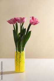 Yellow Filler With Tulips In Glass Vase