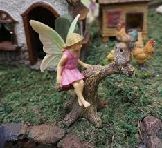 Miniature Fairy Girl In A Tree Branch