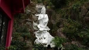 White Statue Of Kuan Yin Riding Dragon