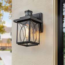 Douglas 1 Light Black Outdoor Motion Sensor Dusk To Dawn Wall Sconce With Seeded Glass