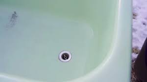 Water Runs Into A Bathtub Drain