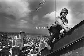 photo of a man on a steel beam above