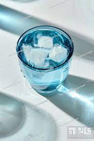 Blue Glass Of Cold Water With Ice Cubes