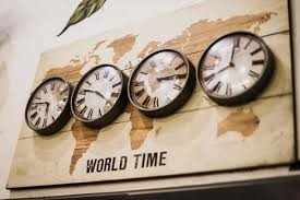 Four Timezone Wall Clocks Showing