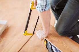 Male Hands Cutting Parquet Floor Board