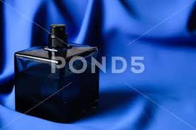 Perfume Spray On A Wavy Blue Background