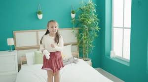 Children Jumping On Bed Stock