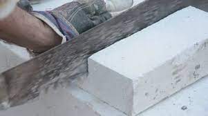 Worker Cutting Lightweight Concrete