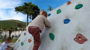 Little Girl Climbing The Climbing Wall